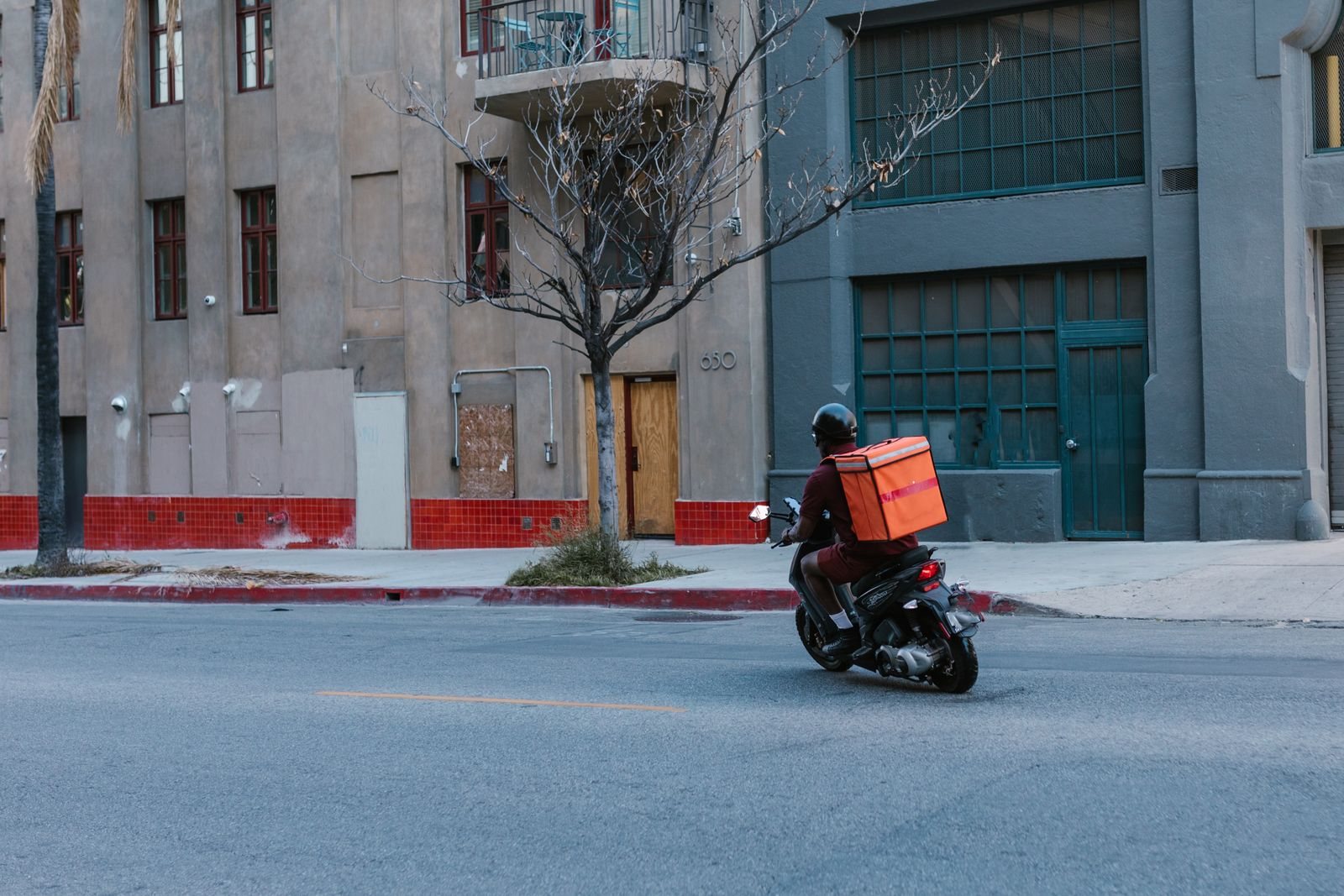 Mensajero en motocicleta con caja de reparto